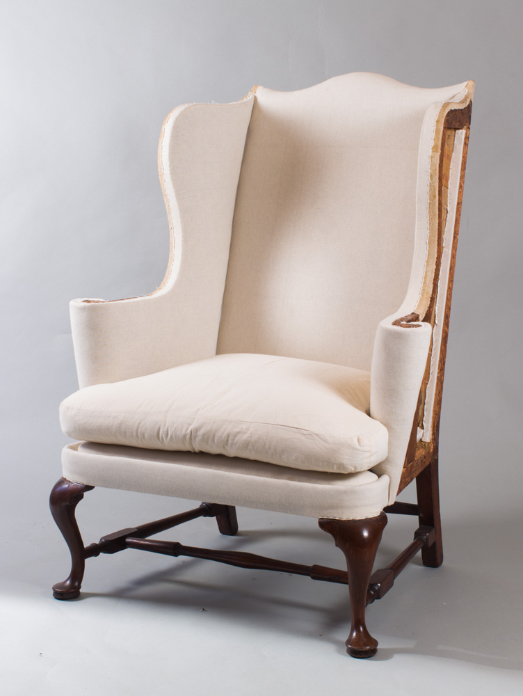 A very fine Queen Anne wing chair with scrolled crest and wings